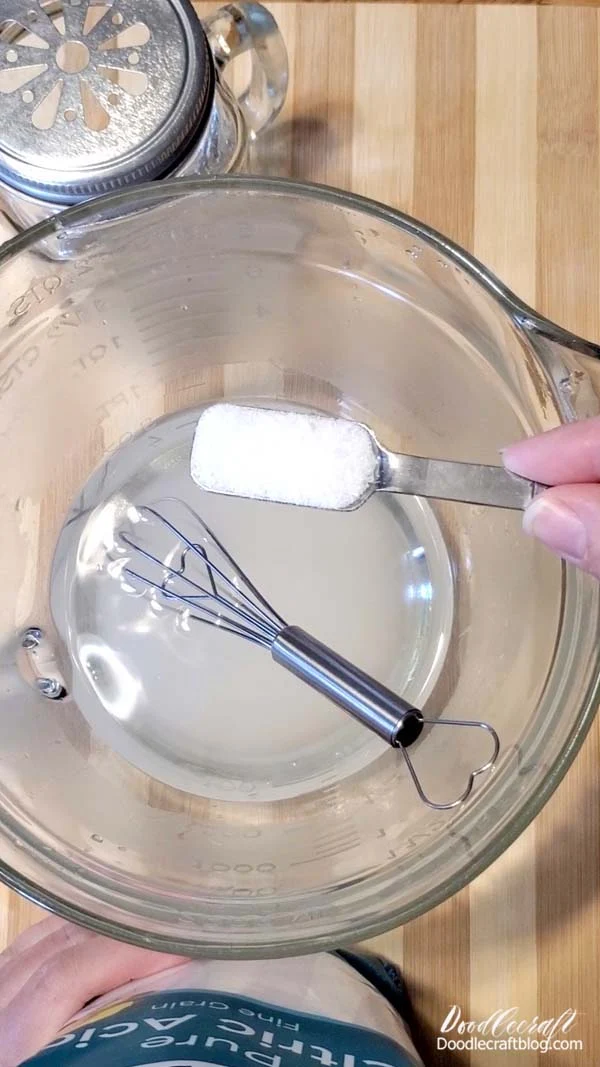 Step 2: Sugar and Acid  Pour 1/2 Cup of sugar into the warm water.   Then add one teaspoon of Citric Acid into the sugar water and stir until dissolved and the water is clear.