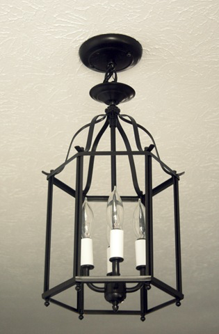 Brass dated fixture to traditional black lantern