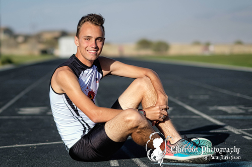 Professional portrait of a high school senior guy at the track