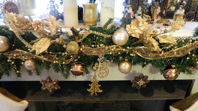 alt="Christmas mantel with pine cone trees and burlap stockings"