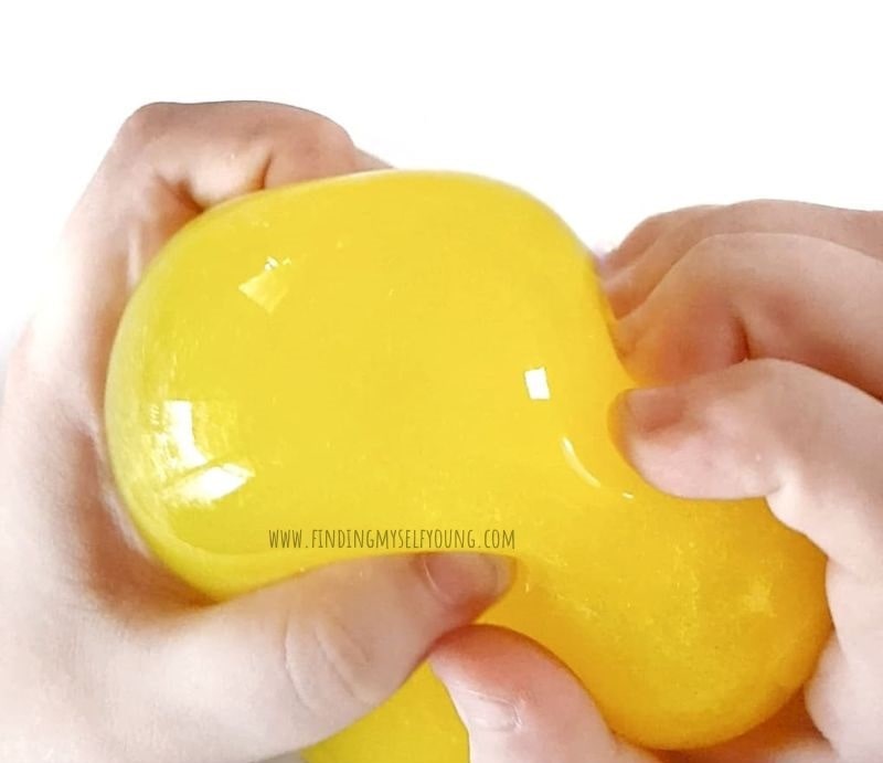 child squeezing yellow squishy