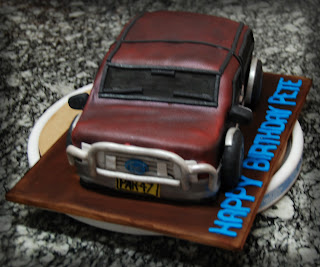 Real red velvet cake with no food colouring, cream cheese frosting to make an F250 birhday cake, carved, crumb coated, fondant covered trimmed, airbrushed with maroon and silver. trim added, bullbar, window and door trim, side mirror, badges, caramel crown tyres