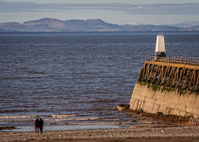 Photo of Maryport's south pier and the Scottish hills