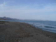 Sat having breakfast on the beach watching people having a dip in the sea . (puntas del calnegre)