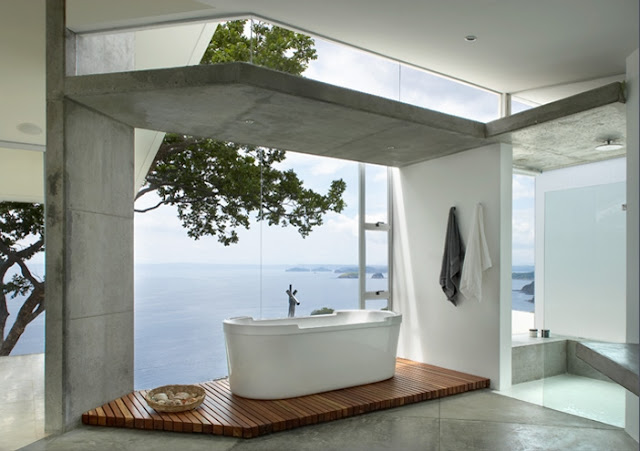 Picture of the minimalist bathtub on the wooden floor by the window overlooking the ocean