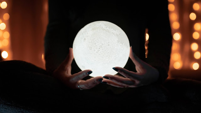 Picture of a woman holding a moon