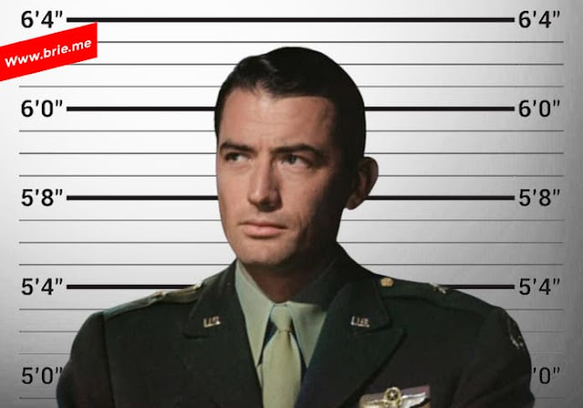 Gregory Peck posing in front of a height chart background