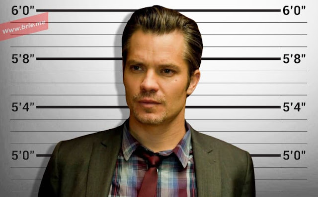 Timothy Olyphant standing in front of a height chart
