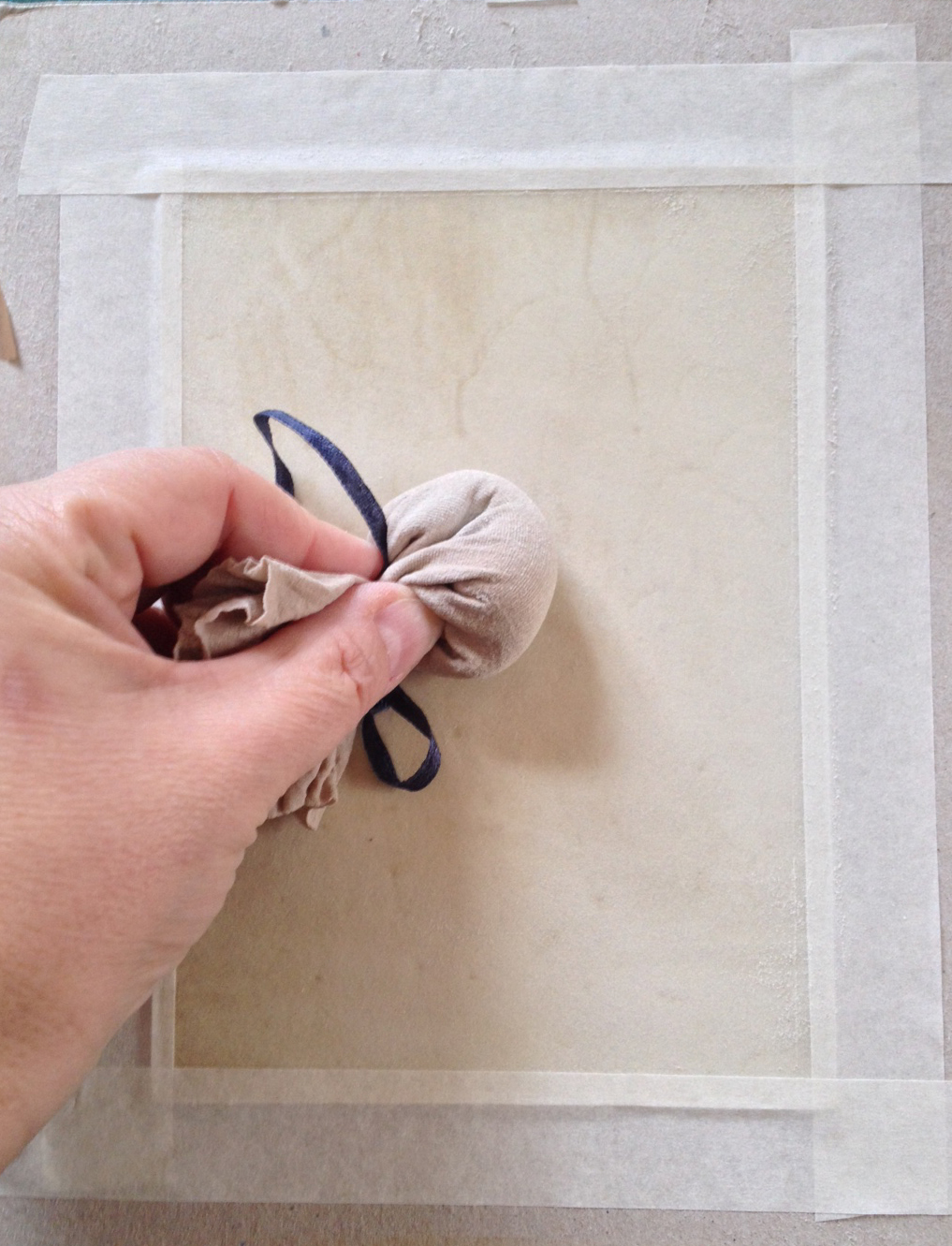 preparing vellum for painting by rubbing with pumice