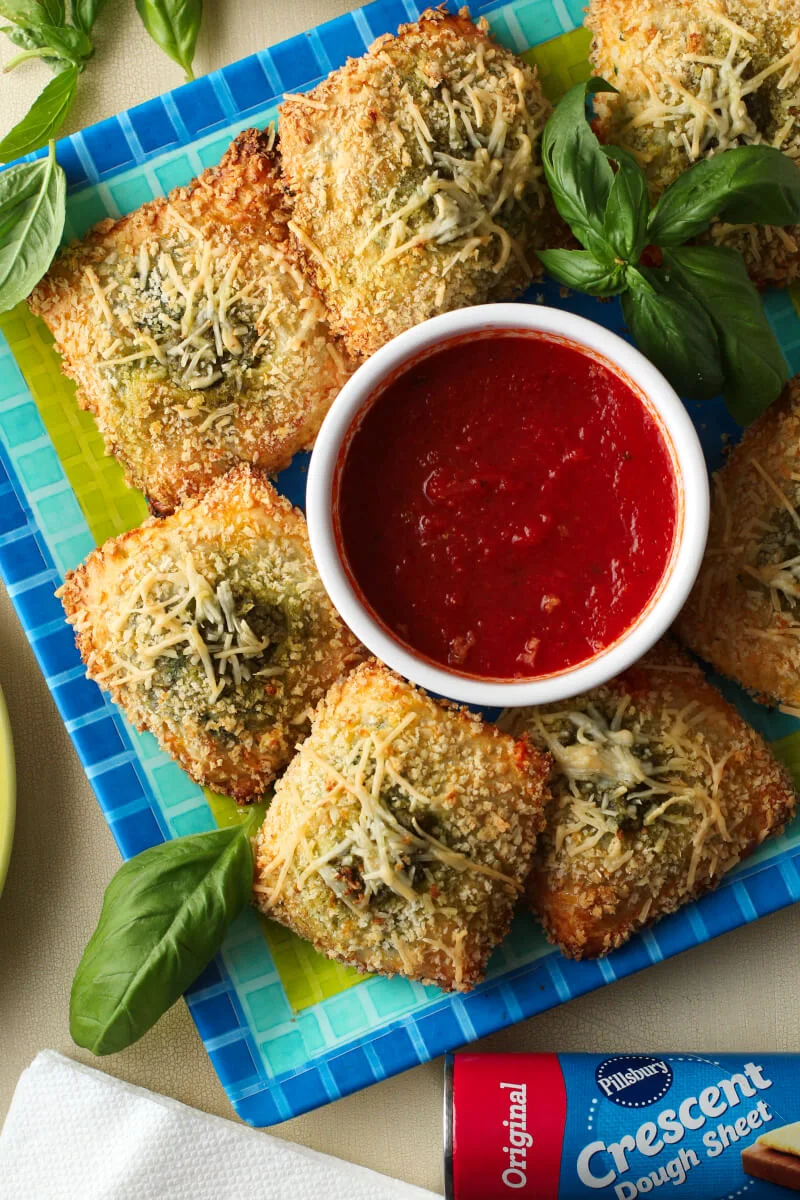 Toasted Spinach Pesto Ravioli, a category winner of the 48th Pillsbury Bake-Off® Contest, is a delicious appetizer recipe perfect for any occasion! #PillsburyBakeOff #MadeAtHome #appetizer #partyfood @Pillsbury #ad