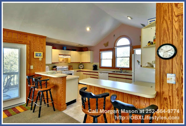 The kitchen of this Outer Banks NC home for sale has new kitchen plumbing, flooring, dishwasher, and other kitchen fixtures. 