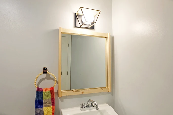 another view of wall mounted mirror with clips scrap wood frame