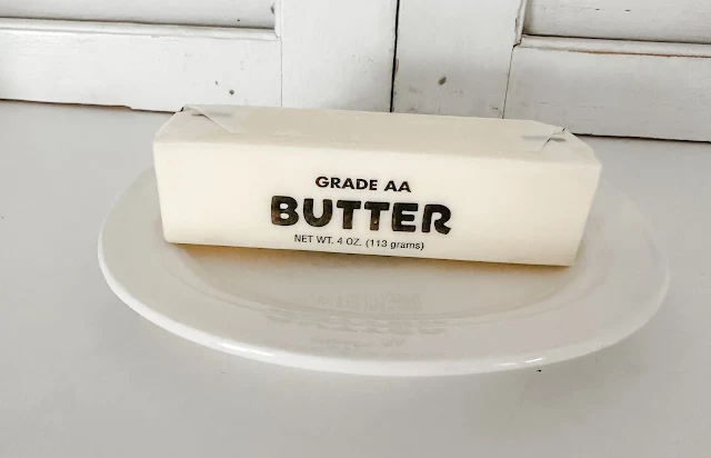 Grade AA butter sitting on butter dish plate