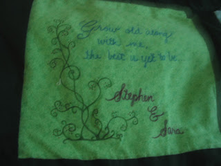 Bright medium green pattered background with fabric painted vine and message.