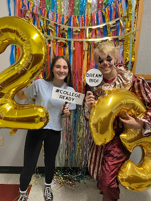 Two Littleton High School seniors pose with balloons.