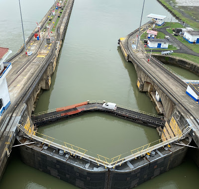 white van driving across a lock of the The Panama Canal