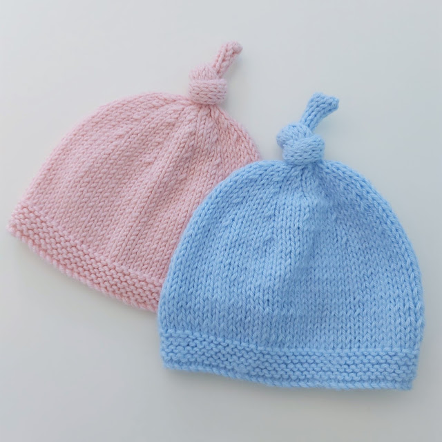 Cute knitted baby hat with topknot