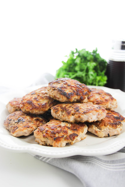 cooked patties piled on a white plate.