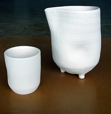 Image of a bisqued clay pitcher and water cup