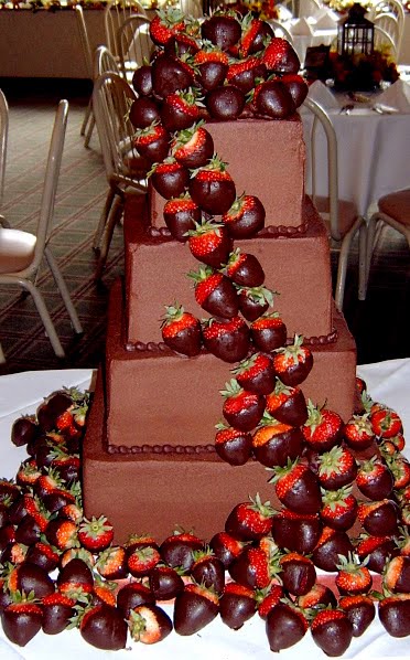 Four tier chocolate wedding cake with chocolate covered strawberries 