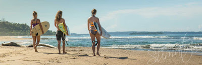 women surfers on beach