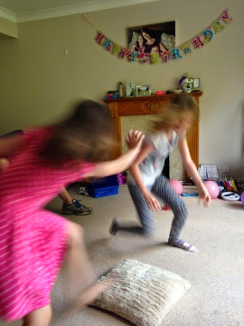 Playing musical cushions; the girls moving super fast!