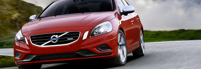 Front view of red 2012 Volvo S60 T6 AWD R SR being driven on winding road