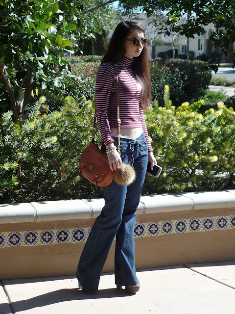 flare jeans outfit idea- cropped turtleneck and boho accessories