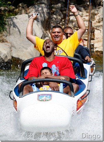 Kobe Bryant there...anyway the guy behind, holding a digital compact cam....