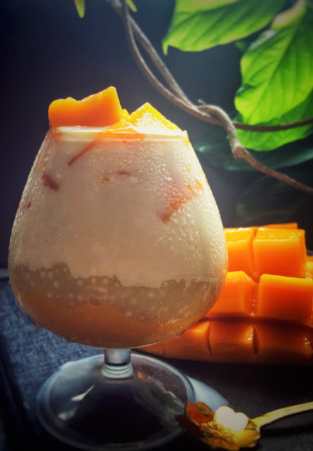 A bowl of Mango Sago Dessert topped with ripe mango chunks, sago pearls, and a drizzle of creamy coconut milk. A refreshing and irresistible Asian dessert to beat the heat!
