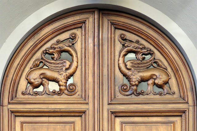 Front door decorated with carved dragons, Via Calzabigi, Livorno