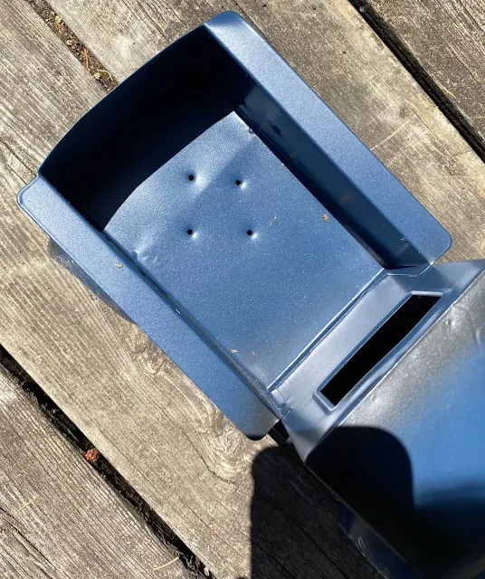 Photo of drainage holes made in the bed of blue metal truck