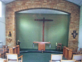 The Chapel at Compton Durville facing the altar with large wall mounted Franciscan Tau Cross