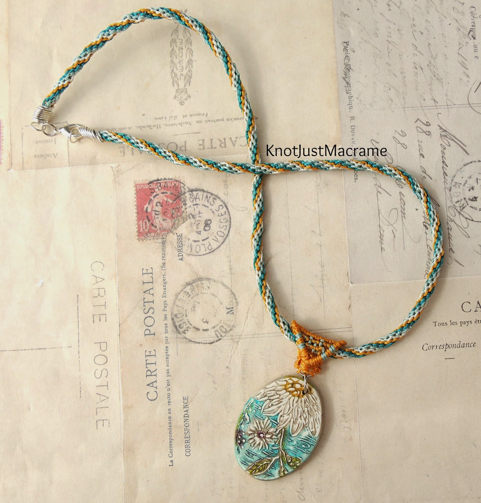 Knotted micro macrame necklace with daisy pendant in teal and mustard.