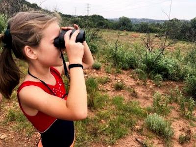 Girl looking through binoculars