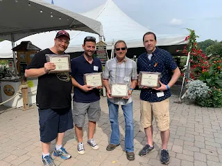 Corcoran Management Company employees posing with their 15 year plaques at Kimball Farm