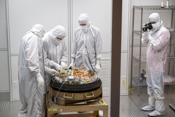 Technicians disassemble OSIRIS-REx's sample return capsule inside a makeshift clean room at the Utah Test and Training Range on September 24, 2023...prior to the capsule being flown to NASA's Johnson Space Center in Houston, Texas, the following day.