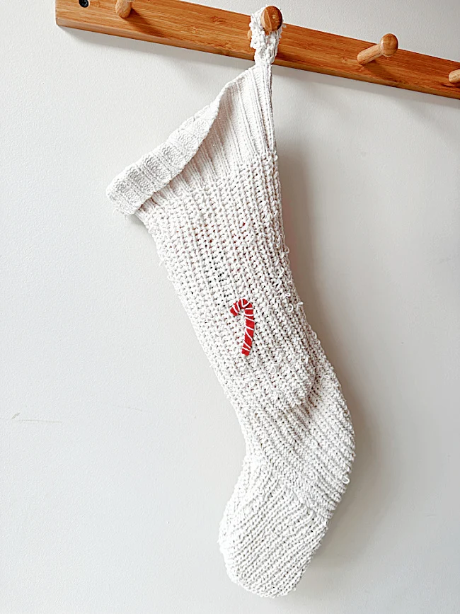 stocking on pegs with candy cane