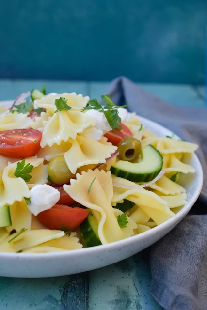 Summer Greek Pasta Salad in a white bowl