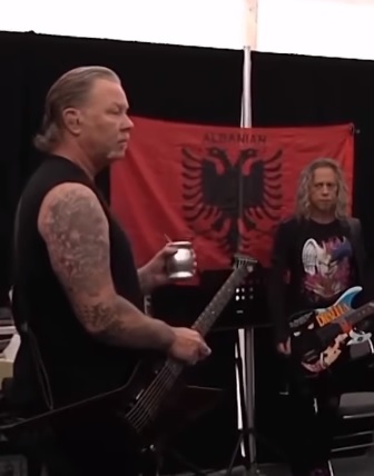 Metallica is seen with the flag of Albania, James Hetfield and Kirk Hammett and in the background the official Albanian flag James Hetfield and Kirk Hammett and in the background the flag of Albania