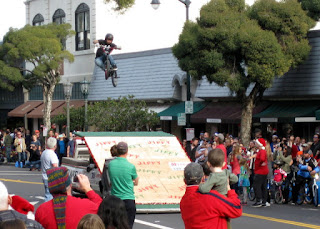 Airborne BMX rider executing a twist above the Jiffy Market ramp, S. Santa Cruz Avenue, Los Gatos, California