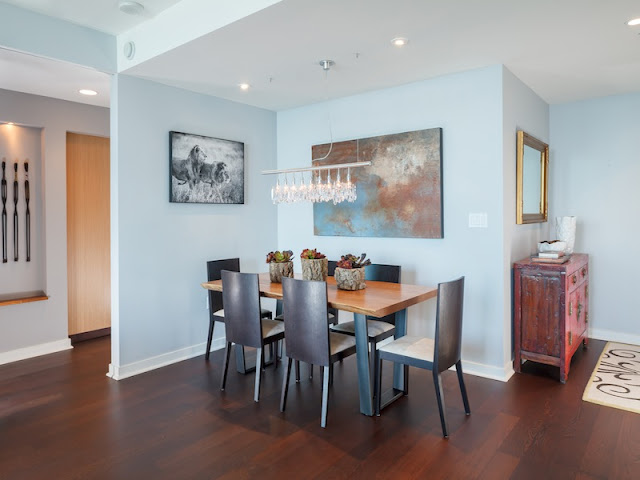 Picture of small dining room with wooden table and black chairs