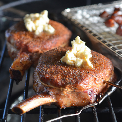 Brown sugar butter melting onto luscious bourbon basted pork chops.