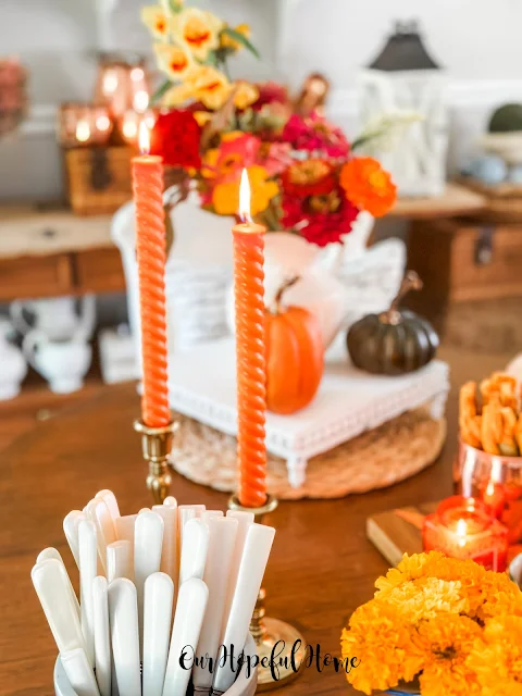 mother of pearl flatware orange candles white riser