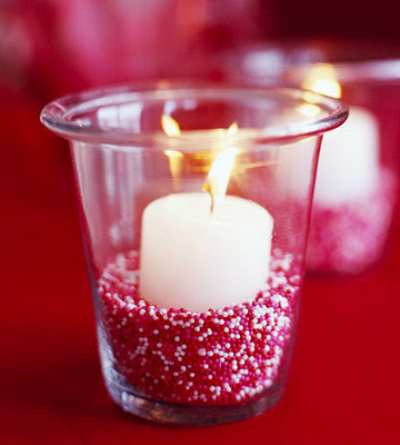 candle in a glass with red back ground