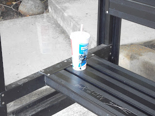 Disposable cup on bus shelter bench