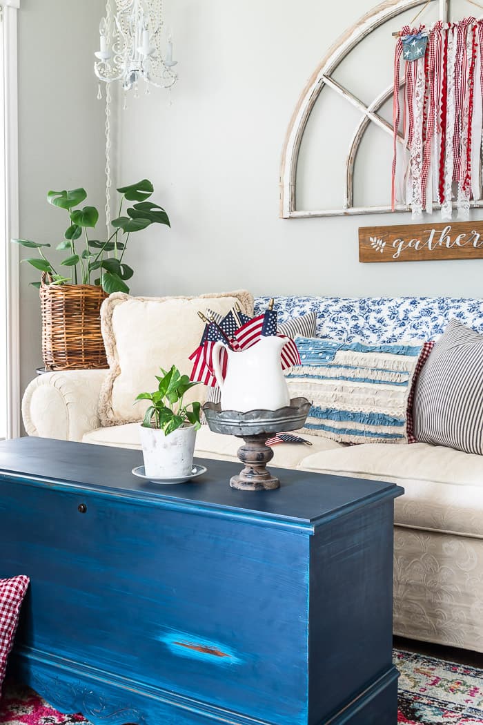 living room patriotic vignette, neutral sofa, blue painted trunk