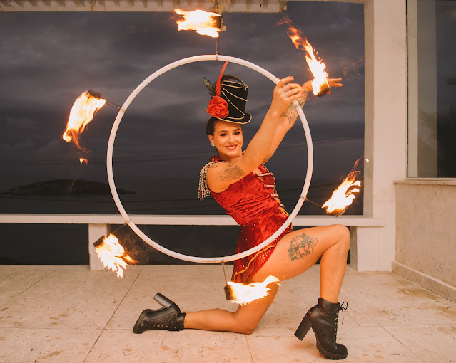 Artista com Bambolê de fogo recepcionando os convidados de festa de casamento.