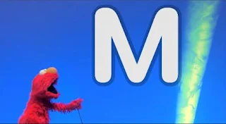 Elmo and friends sing and clap as they find out the letter of the day M. Sesame Street Episode 5005, A Dog and a Song, Season 50.