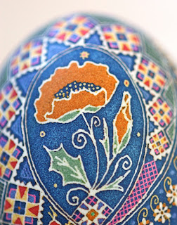 Goose Egg Pysanky with Orange Poppies and Peacocks on Cobalt Blue Background